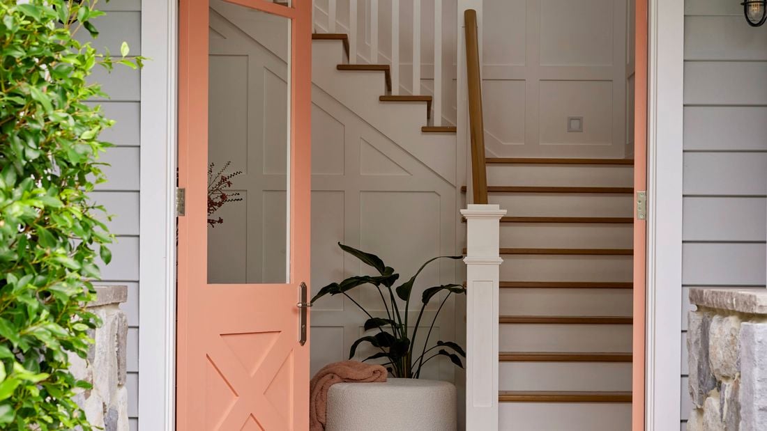 Opened front door leading to a staircase.