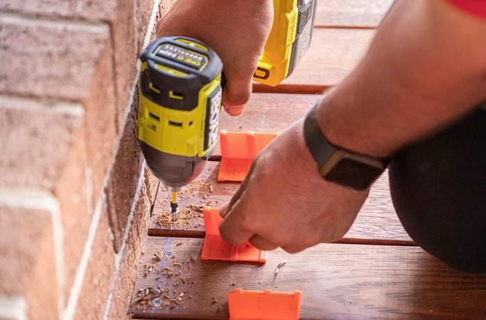 Decking boards being drilled down onto the subfloor