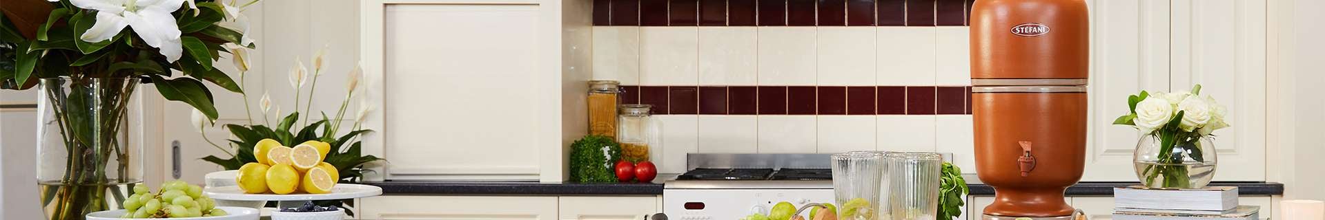 Kitchen with tray of water glasses and water purifier.