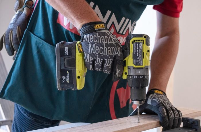 Team member drilling into a mounting board.