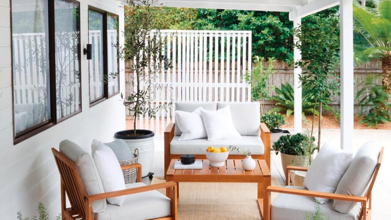 Outdoor furniture is set up in an outdoor, undercover area.
