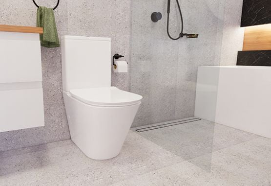 Toilet, grey tiles, glass showerscreen and black tapware