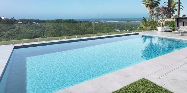 pool fencing around inground pool with sun chairs