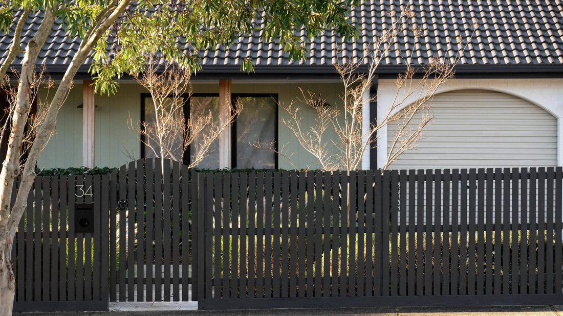 Freshly painted picket fence with a smooth professional finish​