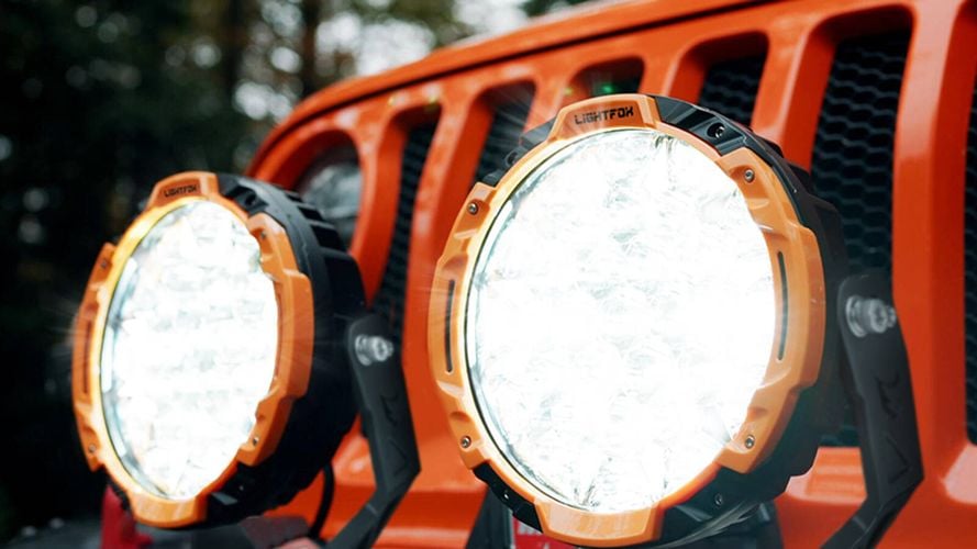 two big head lights on a orange car