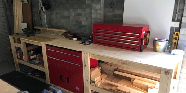 A timber workbench and steel cabinets in a workshop