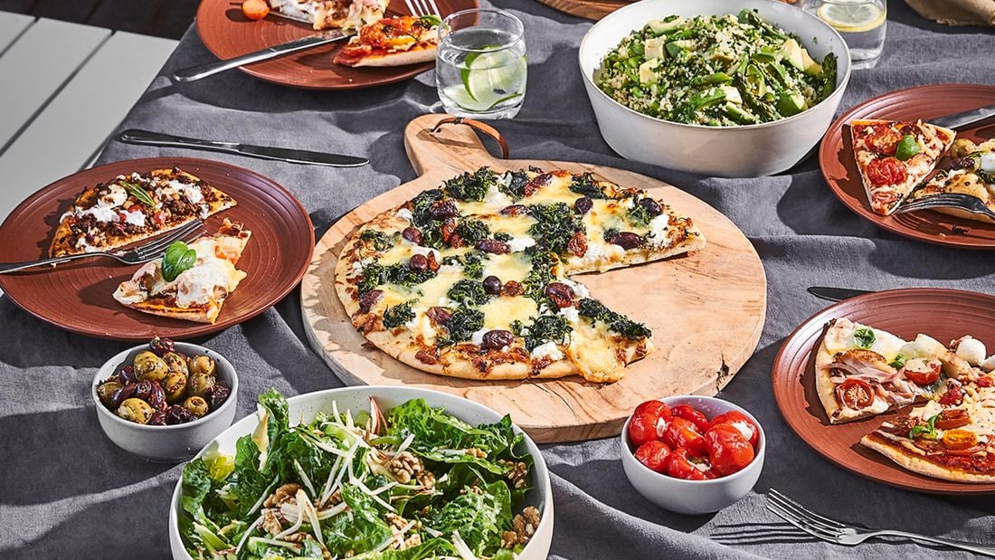 Table set with pizza and salad