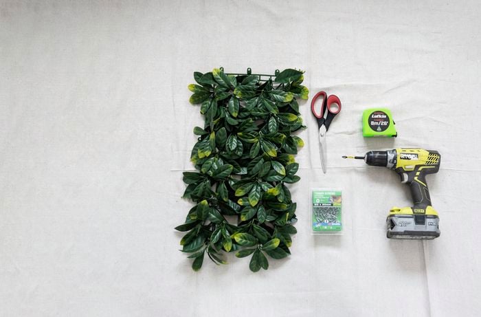 Artificial hedge, nails, scissors, drill and measuring tape.