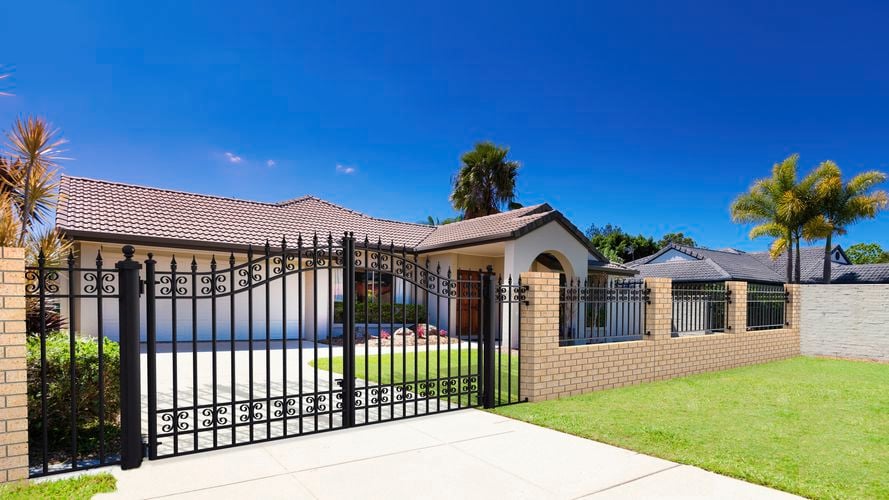 Steel gate and fence installed in front of cream house