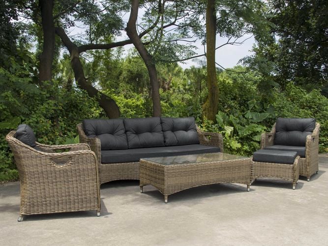 A wicker outdoor lounge setting with two chairs, a sofa and a coffee table