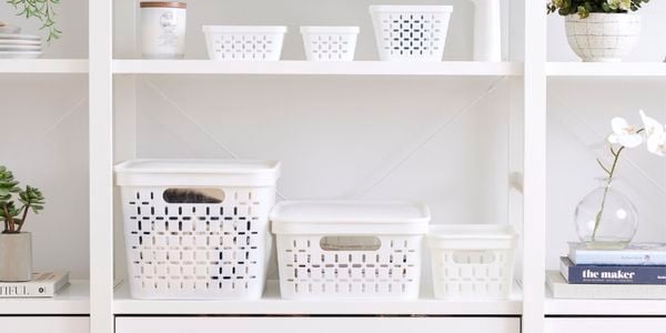 Close up of three white storage containers decreasing in height from left to right.