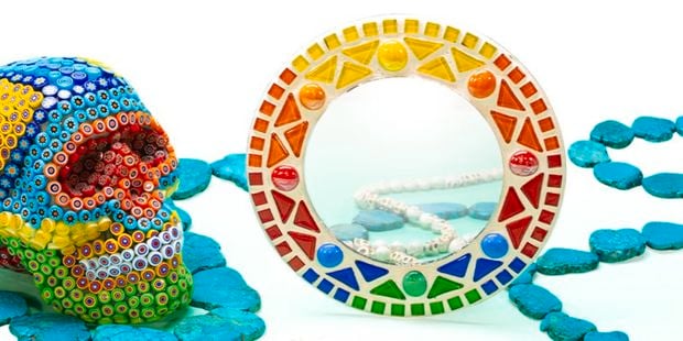 Mirror and skull head decorated with beads and mosaic tiles.