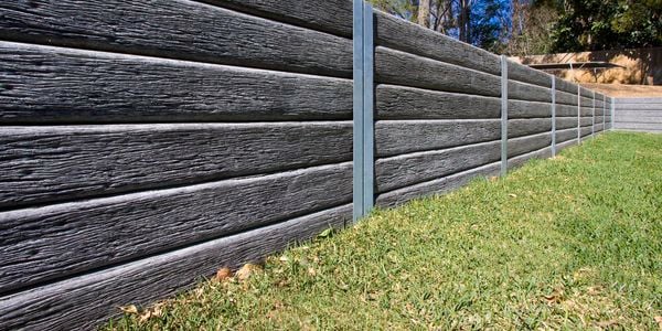 <p>retaining wall with timber sleepers connected by channels&nbsp;</p>