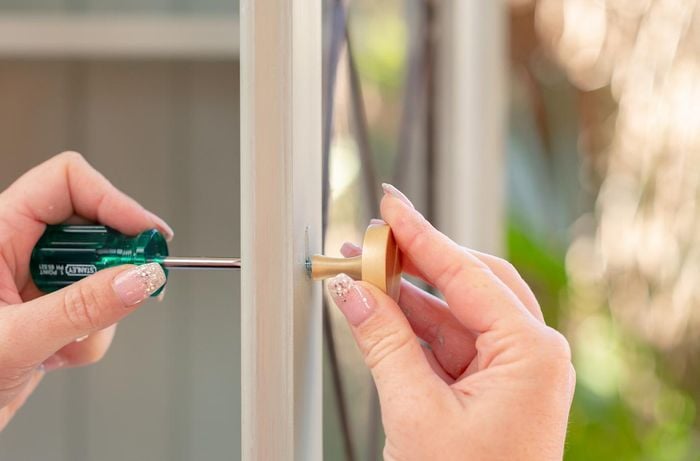 Re-attach doors and handles on kitchen hutch