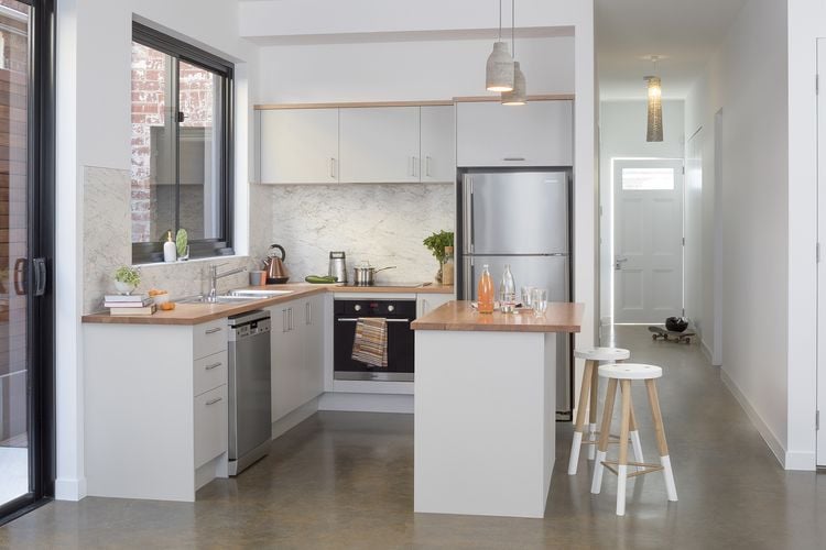 Modern kitchen with timber benchtops and kitchen island with stools