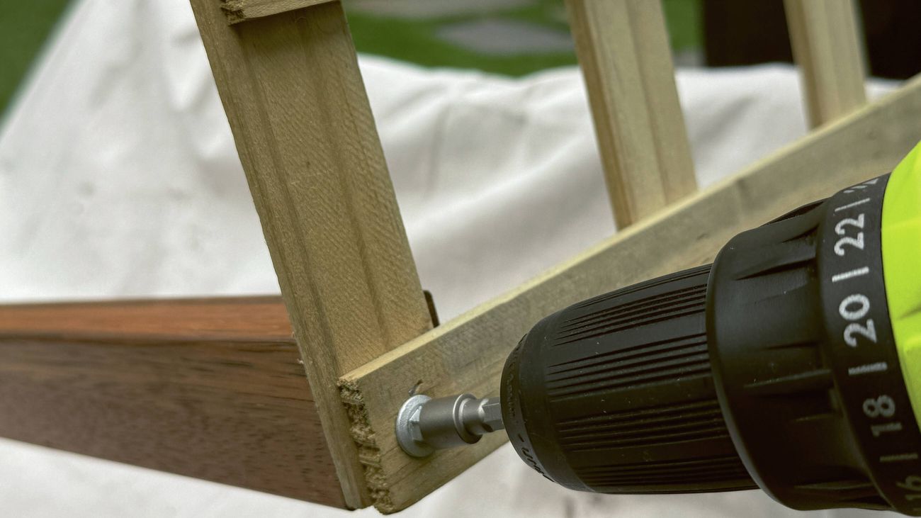  A drill using a nut setter to secure hex head screws into a timber frame