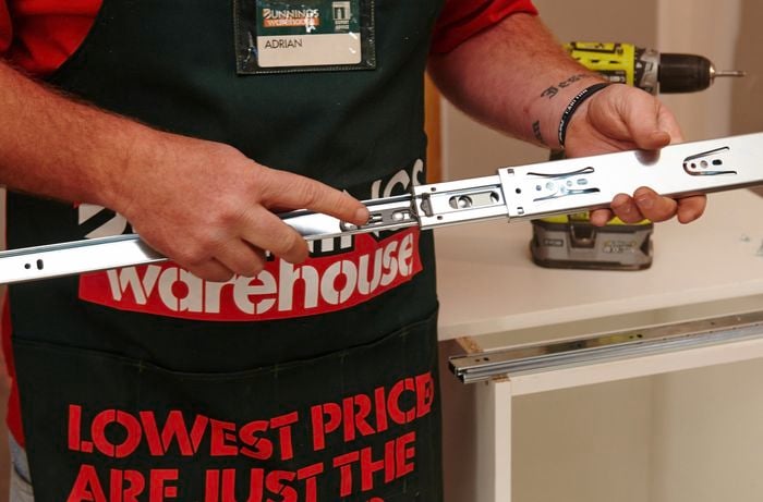 Person separating drawer runners.