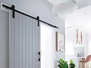 Barn-style sliding door in hallway area.