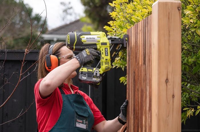 Person nailing the slats using a drill.