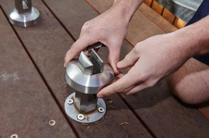 Person securing metal protectors to mini posts.