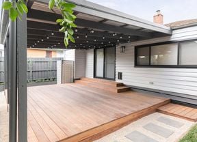 A wall of a weatherboard house painted white