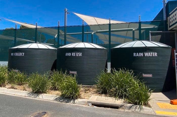 Wodonga rainwater tanks in shot with the three slogans up on the tanks