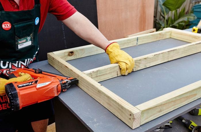 Person drilling timber together.
