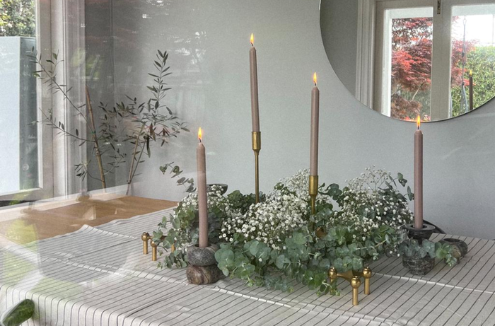 Christmas wreath on table with candles throughout