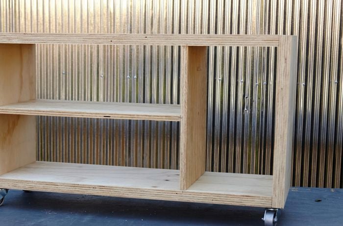 An open timber shelving unit on castor wheels