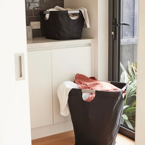 Hills Premium Aluminium Basket and Hamper filled with clothes in a laundry.