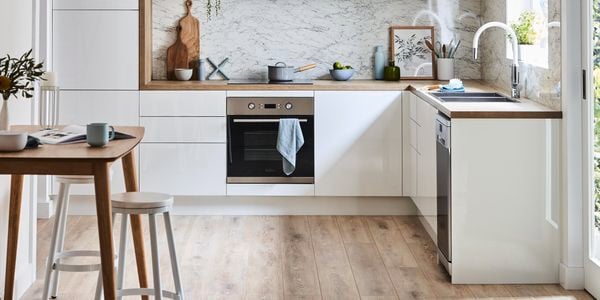White cabinets  - Marble splashback - Wooden dining table - Scandi kitchen - Hero portrait