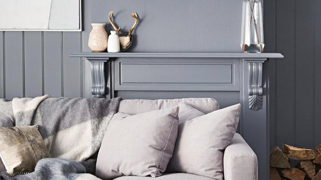 Couch with grey colour palette walls behind.