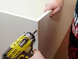 Panels of a kitchen pantry being joined