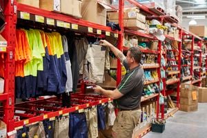Customer in Bunnings aisle looking at workwear.