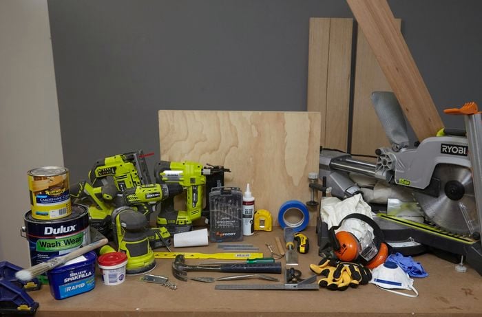 Various tools and materials needed to build DIY wooden step stool.