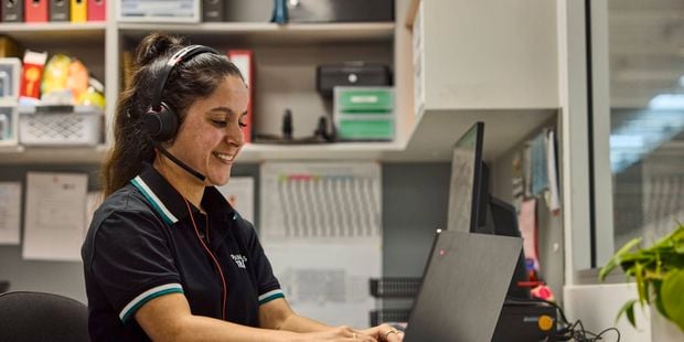 Bunnings team member sitting at her desk and working on her laptop