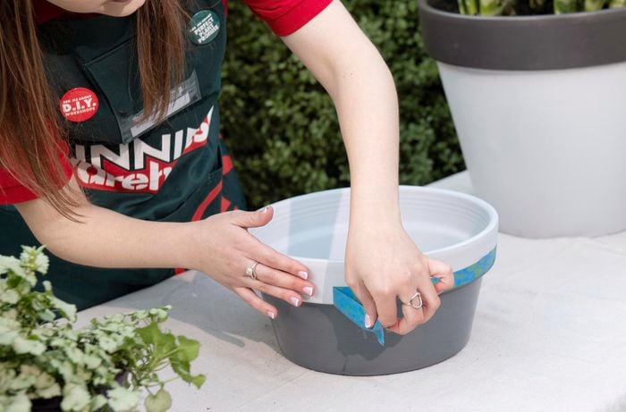 DIY - Step 5 - Team member applying tape to pots - How to upcycle terracotta pots - Emily.jpg