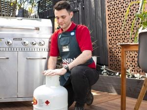A Bunnings Team Member with a gas bottle