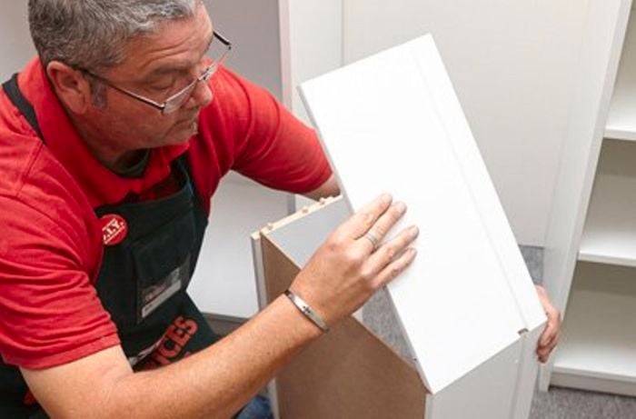 A Bunnings team member assembling a drawer.