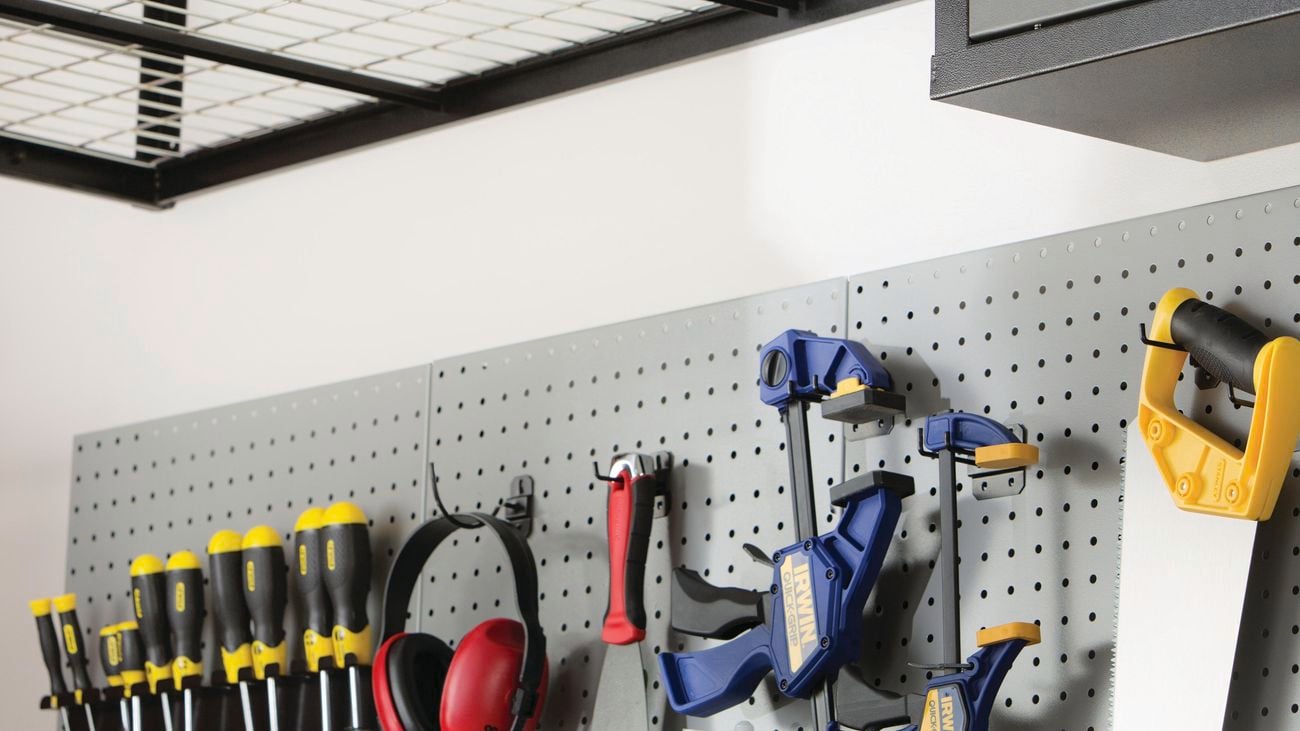 Assortment of tools hanging from shelf.
