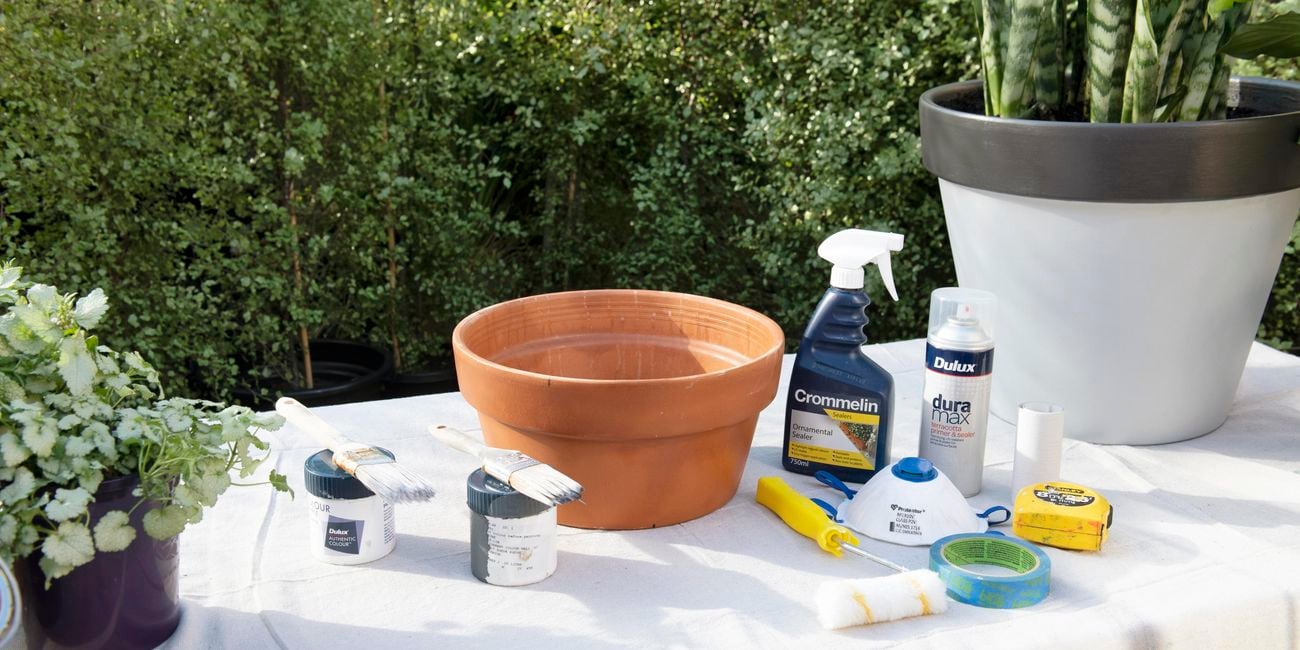 Tools and Materials for - upcycling terracotta pots including pots, paint brushes, paint roller, tape measure, masking tape and dusk mask