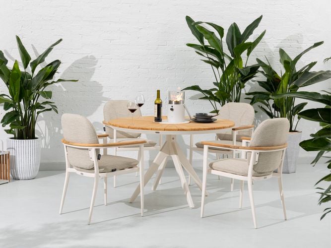 An outdoor dining setting with four aluminium chairs and a round teak table
