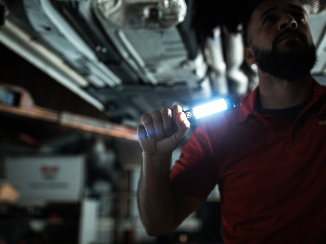 Person holding hand-held light.