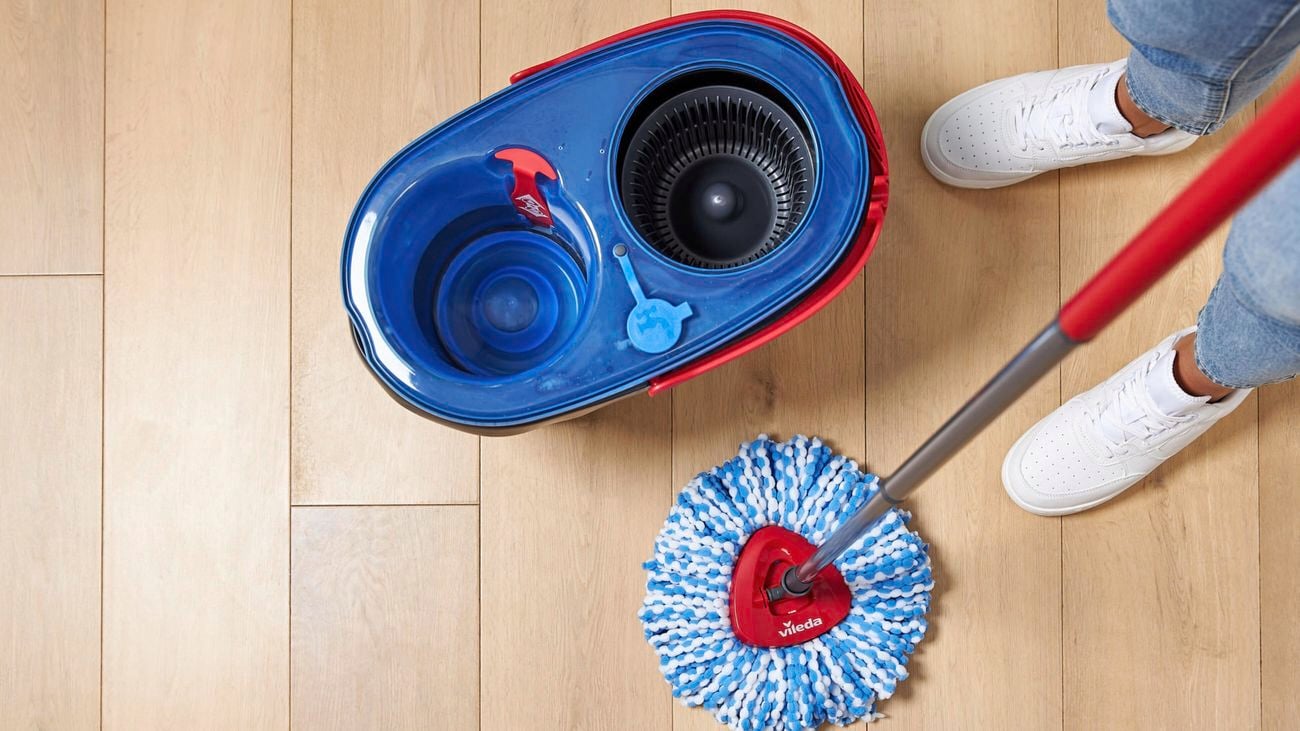 Overhead shot of a Vileda ‘Rinse Clean’ spin mop and bucket on a timber floor