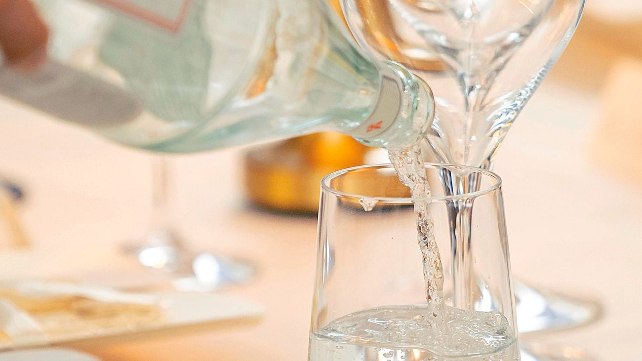 Close-up view of water being poured into a glass cup.