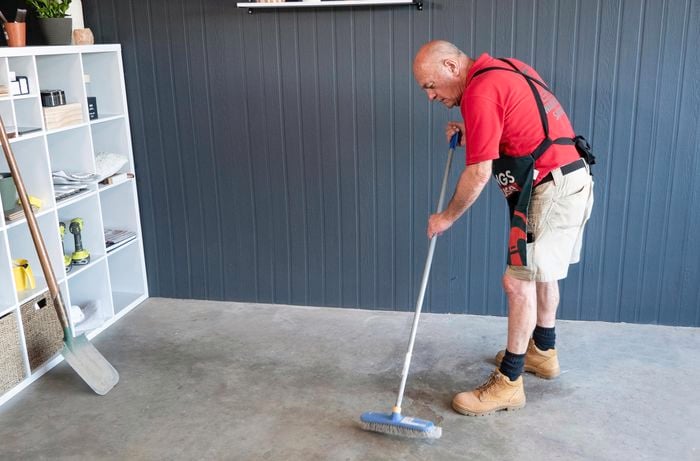 Bunnings team member sweeping garage floor