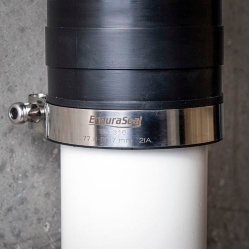 Close up image of a T-bolt hose clamp.