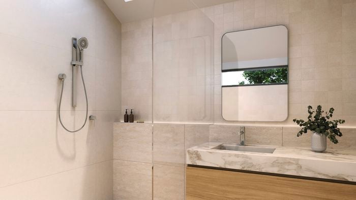 A modern bathroom with a shower, mirror, a marble benchtop with a timer drawer underneath it.