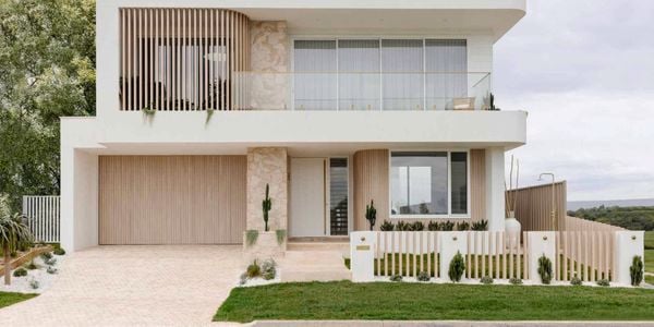 A modern house with cladding and a white exterior.