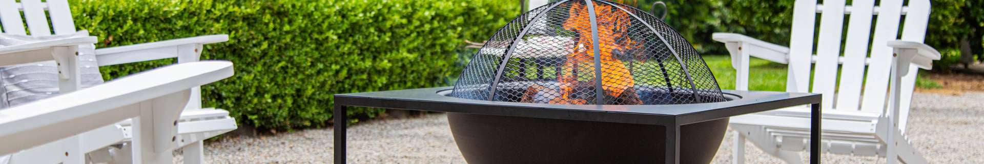 A Glow outdoor fire pit surrounded by outdoor chairs.